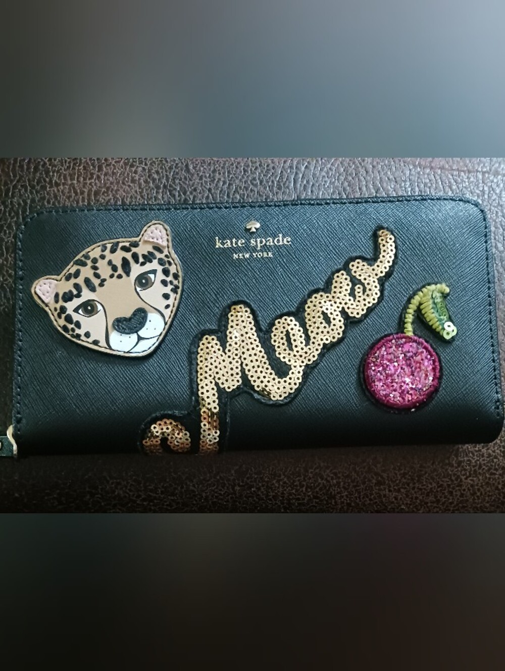 kate spade black wallet with gold sequin patch and leopard detail
